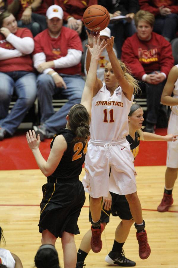 Freshman Jadda Buckely shoots the ball while evading Iowa defense. Buckley scored a total of 19 points, helping the Cyclones pull an 83-70 victory over the Hawkeyes.