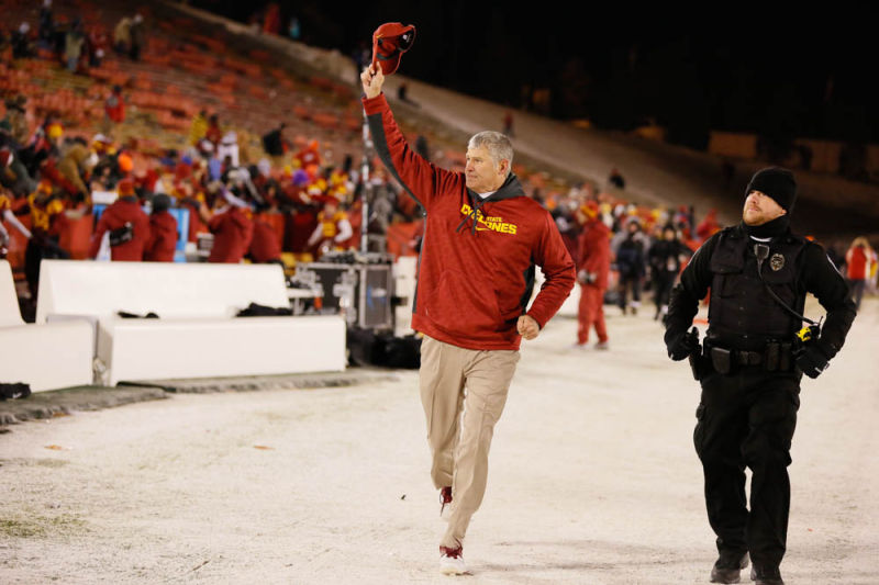 ISU football coach Paul Rhoads tips his cap to Iowa State fans as he and his team circle the field after a 34-0 win on Senior Night against the Kansas Jayhawks on Nov. 23, 2013 at Jack Trice Stadium.