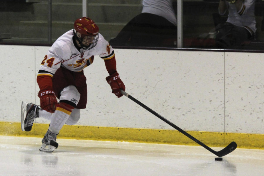 Sophomore forward Austin Parle drives the puck down the rink during a game against Dakota College-Bottineau Dec. 14, 2013. The Cyclones swept the Lumberjacks 7-1.