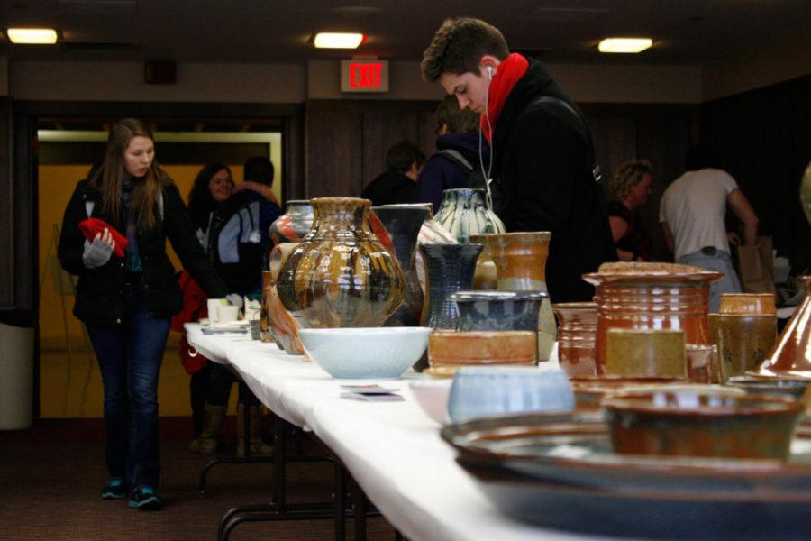 Students peruse glass, pottery, prints, jewelry and more for sale at the WinterFest Art Mart in the Campanile Room of the Memorial Union on Thursday, Dec. 5. Proceeds support organizations and local artists. 