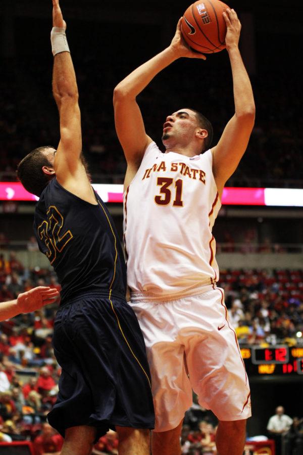 Sophomore Georges Niang attempts to score as Augustanas Casey Schilling blocks the shot during the exhibition game on Sunday, Nov. 3, at Hilton Coliseum. Niang scored 10 points for the Cyclones.