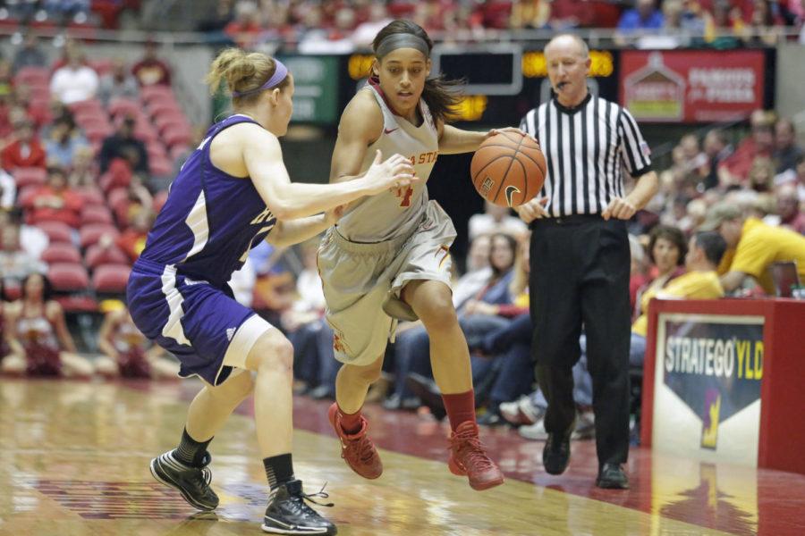 Junior guard Nikki Moody dribbles up the court during Iowa States 72-50 win over Holy Cross on Dec. 28, 2013, at Hilton Coliseum. Moody finished the game with a double double with 14 points and 10 rebounds.