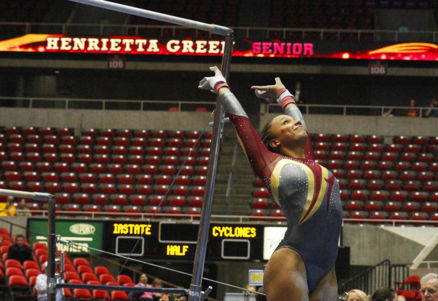 Senior Henrietta Green sticks the landing during on uneven bars in the womens gymnastics meet with Michigan and Illinois State on Jan. 10 at Hilton Coliseum. Green scored a 9.750 in the uneven bars in the Cyclones second place finish behind Michigan.