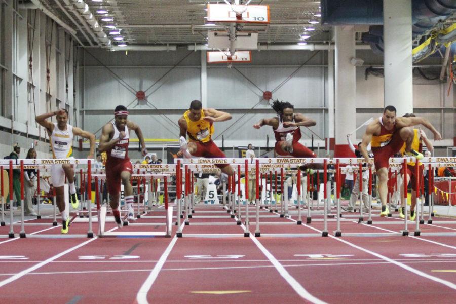 Runners jump over hurdles in the 60-meter hurdles during the Big 12 Indoor Track and Field Championships on Saturday, Feb. 23, at Lied Recreational Athletic Center. ISU runners junior Ryan Sander and senior Troy Walls qualified for the finals during this heat.
