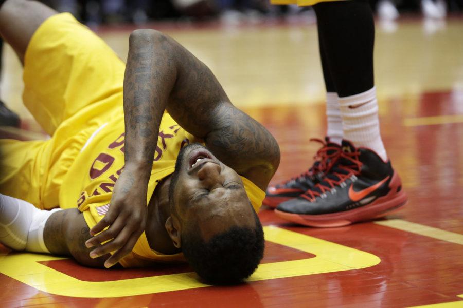 Senior guard DeAndre Kane lays on the floor in pain after taking a knee to his thigh during Iowa States 77-70 loss to Kansas on Jan. 13 at Hilton Coliseum. Kane had 21 points, eight rebounds and four steals.