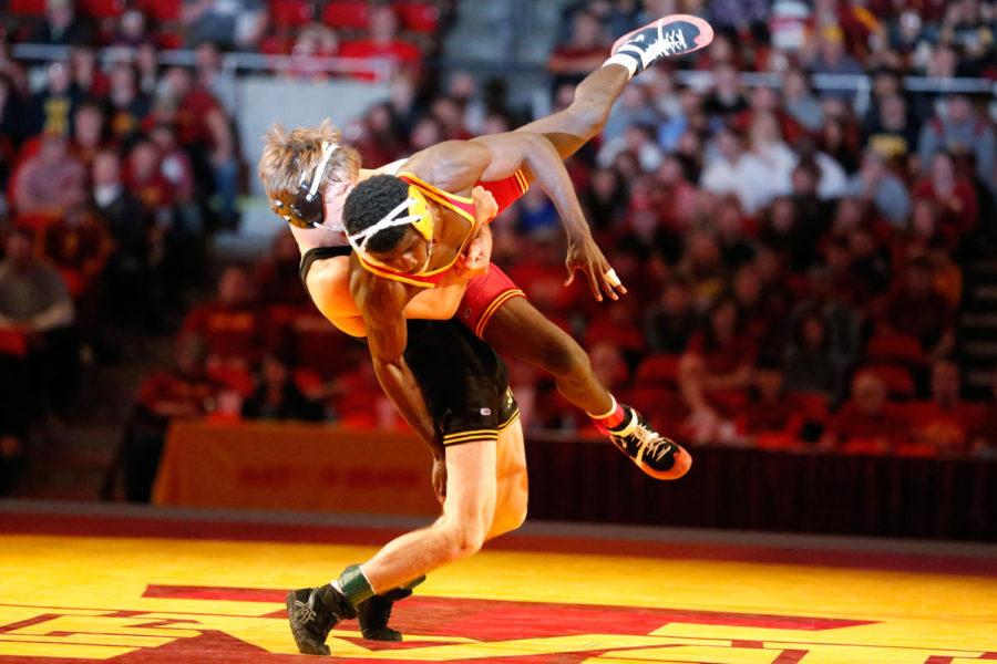 Sophomore Earl Hall, 125 pounds, gets thrown to the floor during his match against Iowas Cory Clark on Dec. 1 at Hilton Coliseum. Hall would lose by decision to Clark. Iowa State lost the dual to Iowa 23 to 9. 