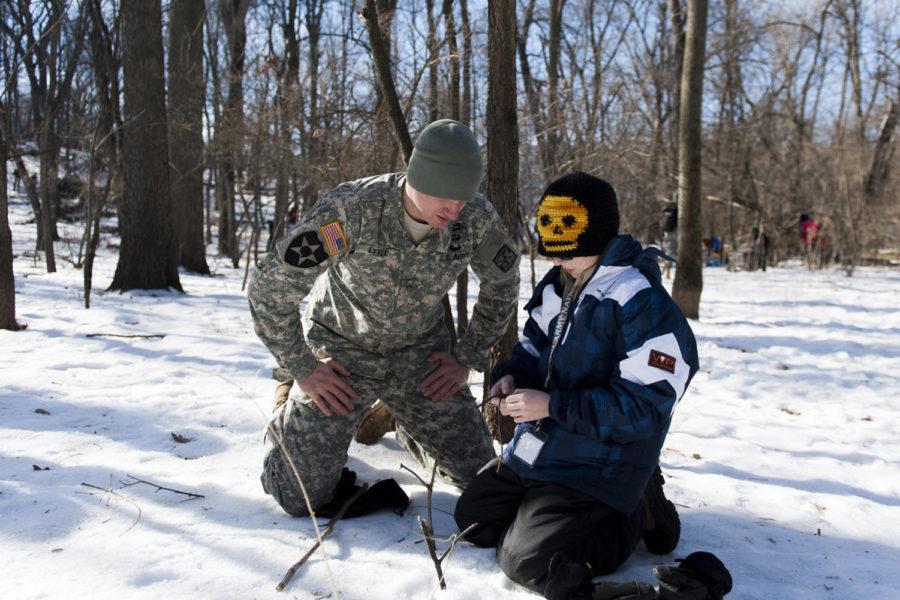 Milliam Lytle, junior in history, and Drew Kart on the right show how to set up the trap to catch small animals in the field. ISU Army ROTC department held Boy Scout Winter Survival event at Pamel Woods and inside Armory on Jan 25.