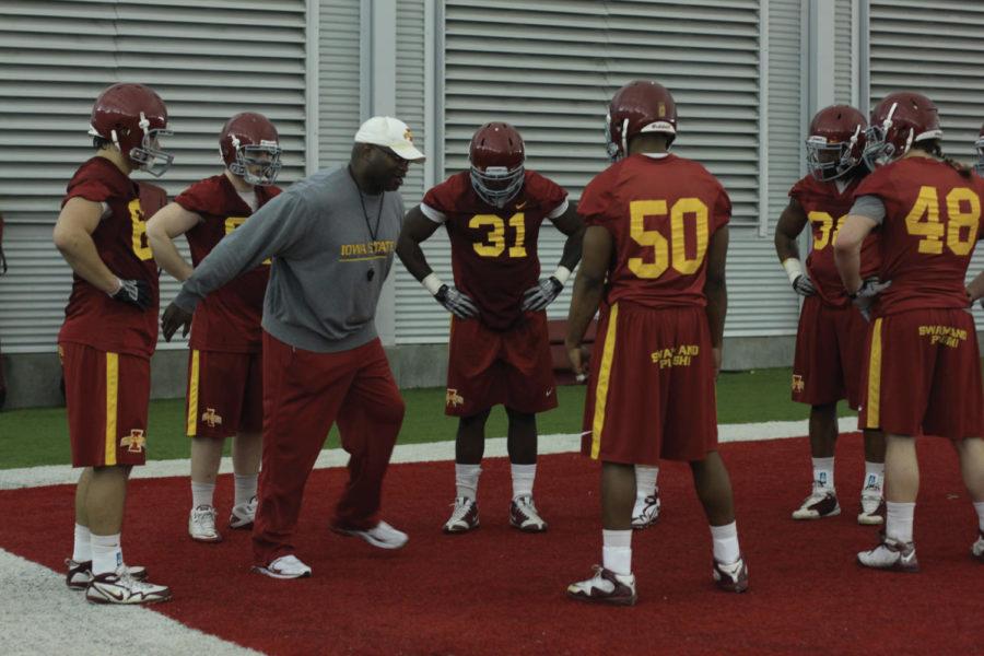 Assistant coach Curtis Bray trains players during football practice Tuesday, March 22, 2011, at the Bergstrom Indoor Practice Facility.