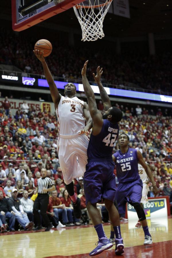 Senior forward Melvin Ejim attempts to lay the ball up and in over a Kansas State player during Iowa States 81-75 win over Kansas State on Jan. 25 at Hilton Coliseum. Ejim lead the Cyclones in scoring with 20 points.