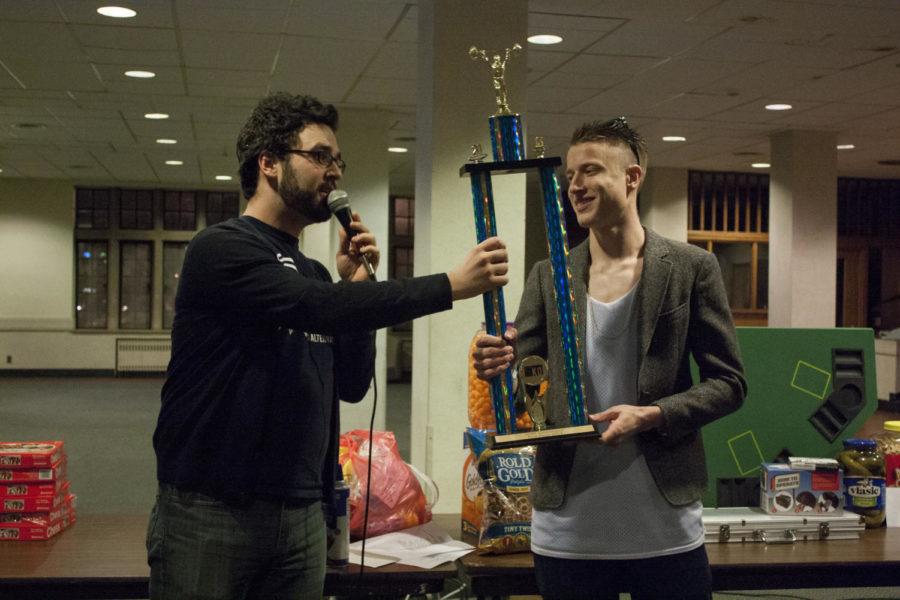 Trevin Ward, Internal Music Director of KURE, presents the first place trophy to the captain of Team Newton Force on Saturday, March 2, 2013, in Friley Hall.
