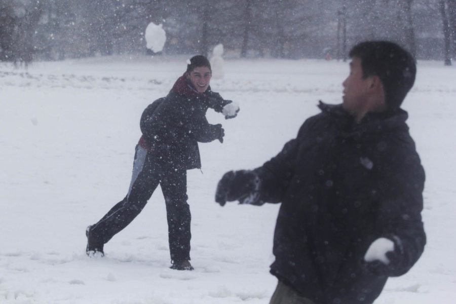 Bryan Cote, sophomore in chemical engineering, throws a snowball at Max Lin, senior in management information systems, on Central Campus on Feb. 20. Classes were canceled after 12:40 p.m. due to the inclement weather.
