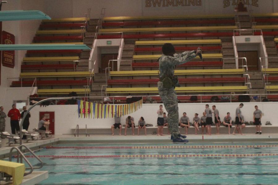 An+Army+ROTC+student+jumps+in+the+water+in+their+uniform+with+gun+on+Feb.+19+at+Beyer+pool.