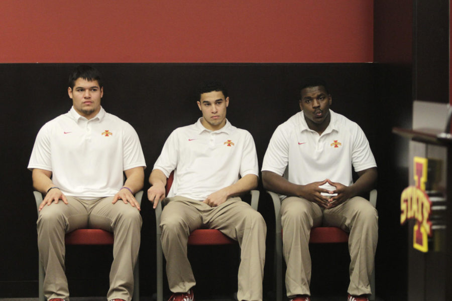Three of the Cyclone football junior college recruits, Gabe Luna, Devron Moore and Jordan Harris, listen to coach Paul Rhoads speak during the National Signing Day press conference Feb. 5. The three recruits enrolled in classes at Iowa State this January and will play defense in the fall.
