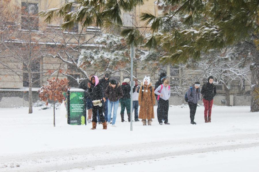 Students huddle at the bus stop outside of Bearshear Hall on Feb. 26, 2013.