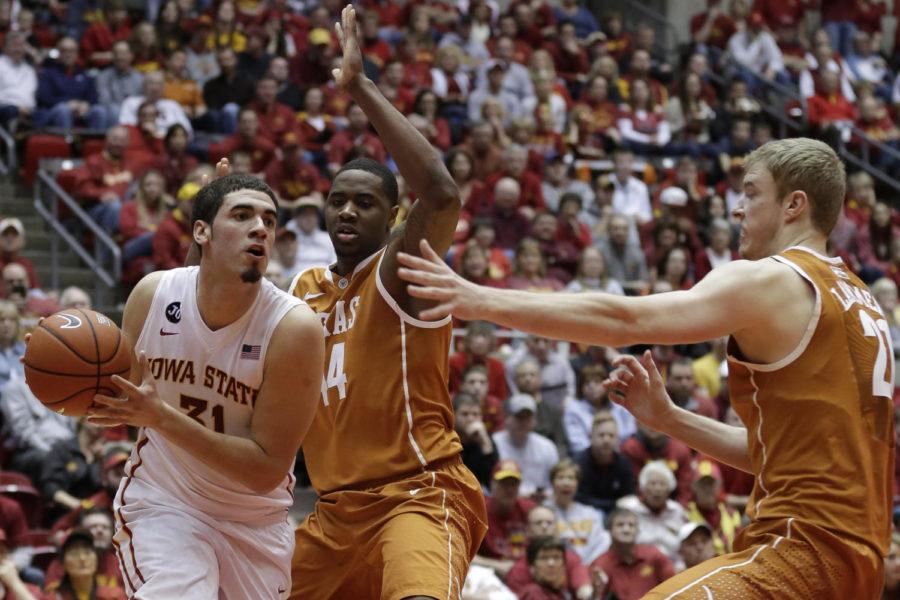 Sophomore forward Georges Niang drives towards the basket through two Texas players during Iowa States 85-76 win over Texas Feb. 18 at Hilton Coliseum. Niang had 20 points, five assists and four rebounds in the game.