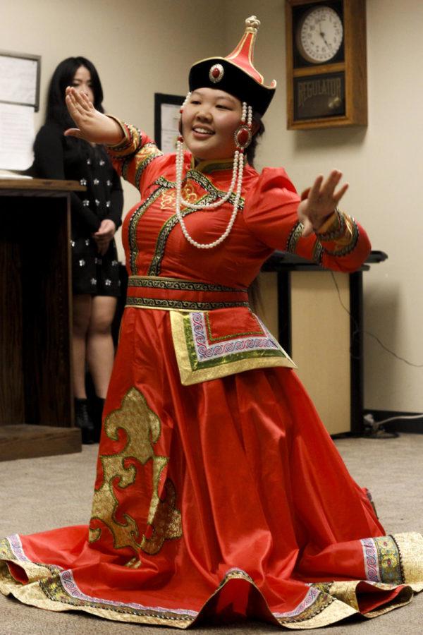 Terigele, a graduate student, performs a traditional dance from Chinese culture in part of the celebration at the Greenlee School of Journalism and Communication on Feb. 7. Students and faculty gathered to commemorate the Chinese New Year by eating and watching performances from a multitude of students. 