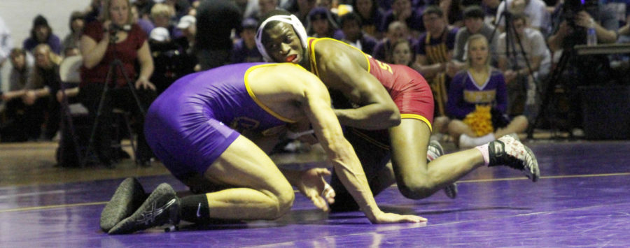 Junior Kyven Gadson wrestles against Northern Iowas Basil Minto at 197 pounds at West Gymnasium on Feb. 8. Gadson won his match 11-3, but the Cyclones lost 13-24.