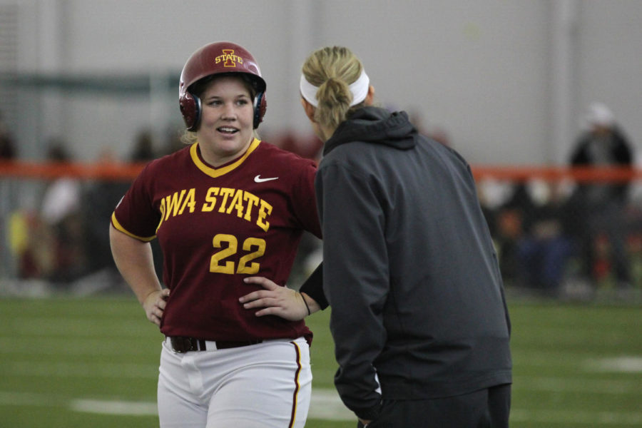 Senior Sara Rice speaks with a coach while on first base during the Cyclones game against South Dakota State at the Bergstrom Football Complex on Feb. 9. The Cyclones beat the Jackrabbits 4-1.