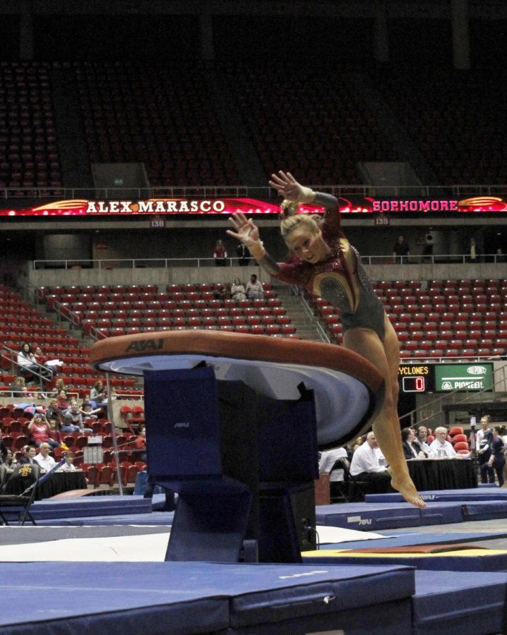 Sophomore Alex Marasco attempts the vault in the womens gymnastics meet with Michigan and Illinois State on Jan. 10 at Hilton Coliseum. Marasco scored a 9.675 in the vault in the Cyclones second place finish behind Michigan.