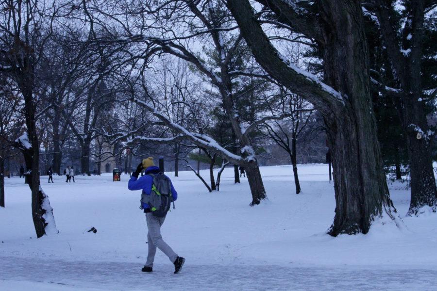 A student walks to class through a snowstorm on Central Campus on Feb. 3. Columnist Wandschneider believes the university should consider canceling classes on days with brutal temperatures and wind chills in order to protect students walking from class to class. 