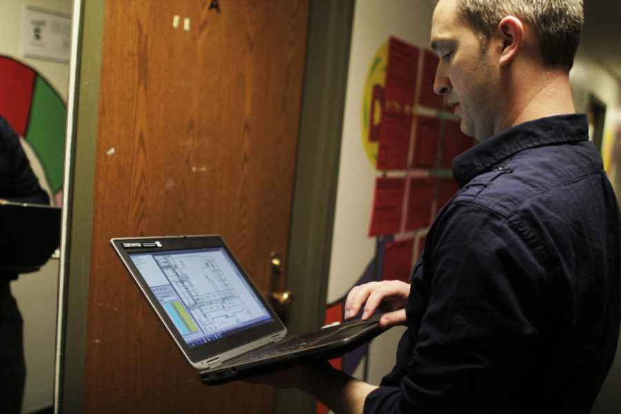 Mike Broders, IT Services engineer working on the wireless project, walks through Friley Hall, recording data for the project. Engineers like Broders are mapping the coverage and signal strength of the Wi-Fi in all the campus residence halls and academic buildings.