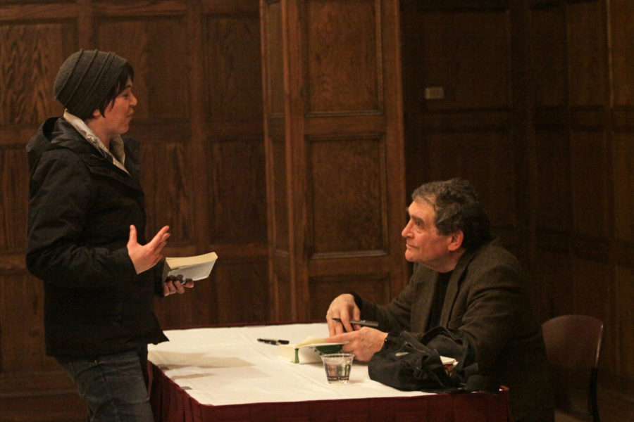 Meg Brown, graduate student in English, speaks with Alan Weisman while he signs her book after his lecture on sustainability Monday, Feb. 24, in the Great Hall.