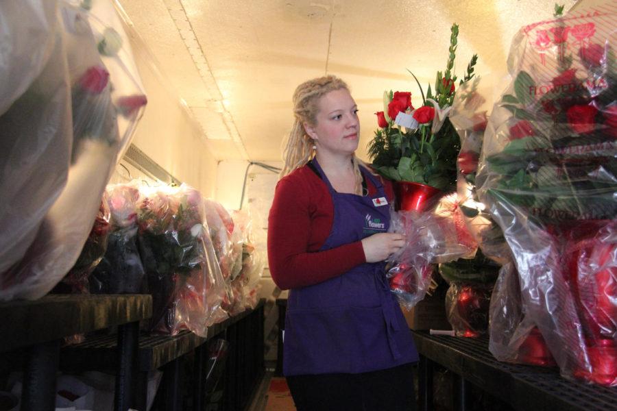 Rachel Carr, a florist at Flowerama in Ames, tends to back stock for Valentines Day deliveries. Flowerama ordered in excess of 13,000 roses along with 2,000 carnations and 400 star-gazer lilies. Carr, along with other florists, prepares next day orders for both delivery and pick-up while assisting those in the store. 
