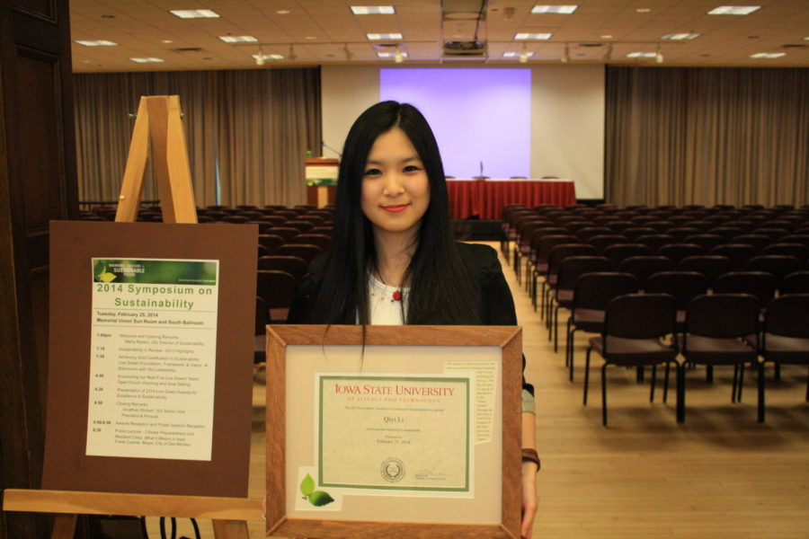 Qiyi Li, senior in landscape architecture, holds her award of Excellence of Sustainability at Sustainapalooza.