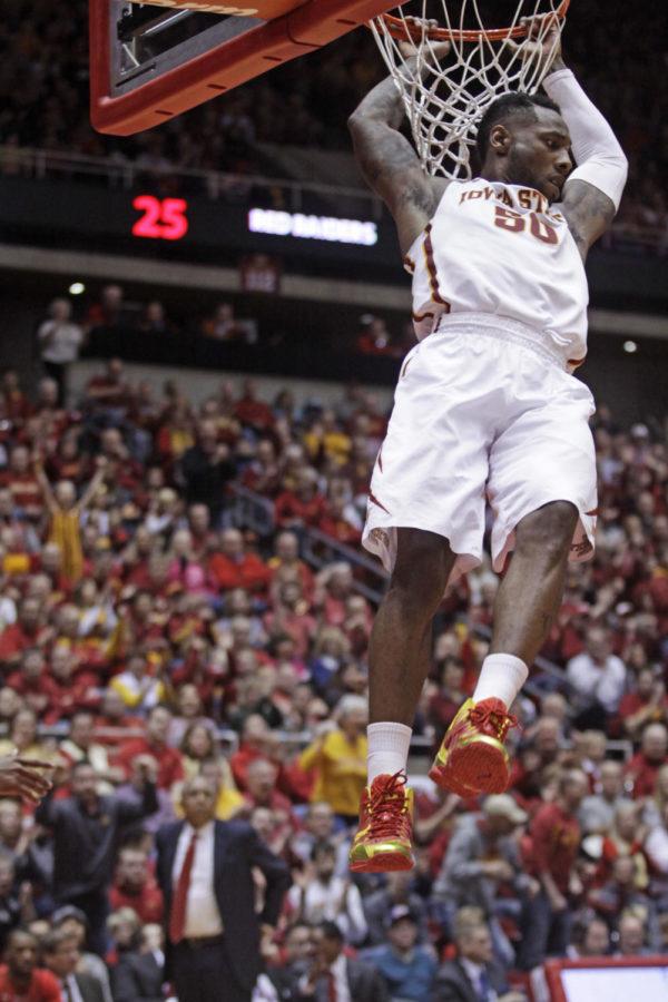 Senior guard DeAndre Kane hangs off the rim after dunking the ball against Texas Tech on Feb. 15. Kane had 17 points for Iowa State. The No. 11 Cyclones defeated the Red Raiders 70-64.