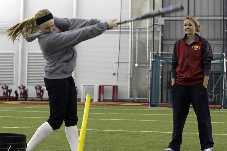 Assistant Coach Lindsey Ubrun oversees senior Sara Davidson during some prepractice hitting on March 11 at the Bergstrom Football Complex.