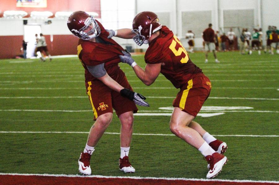 Senior defensive end Cory Morrissey practices a drill during the first spring training on March 10 at Bergstrom Football Complex. Morrissey returns this season after leading the defensive line in tackles during the 2013 season.