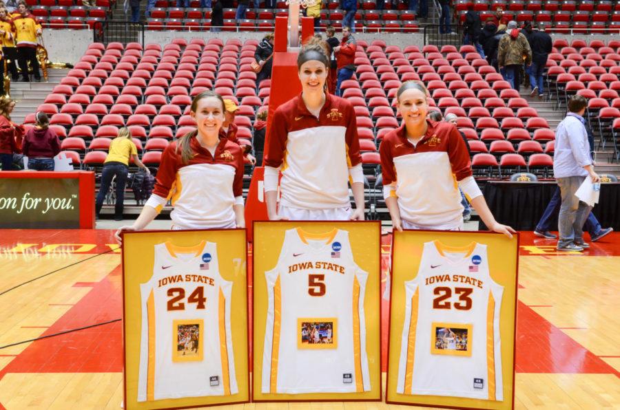 Elly Arganbright, Hallie Christofferson and Ashley Hagedorn take a group picture after receiving their jersey during senior day on March 4 at Hilton Coliseum. 