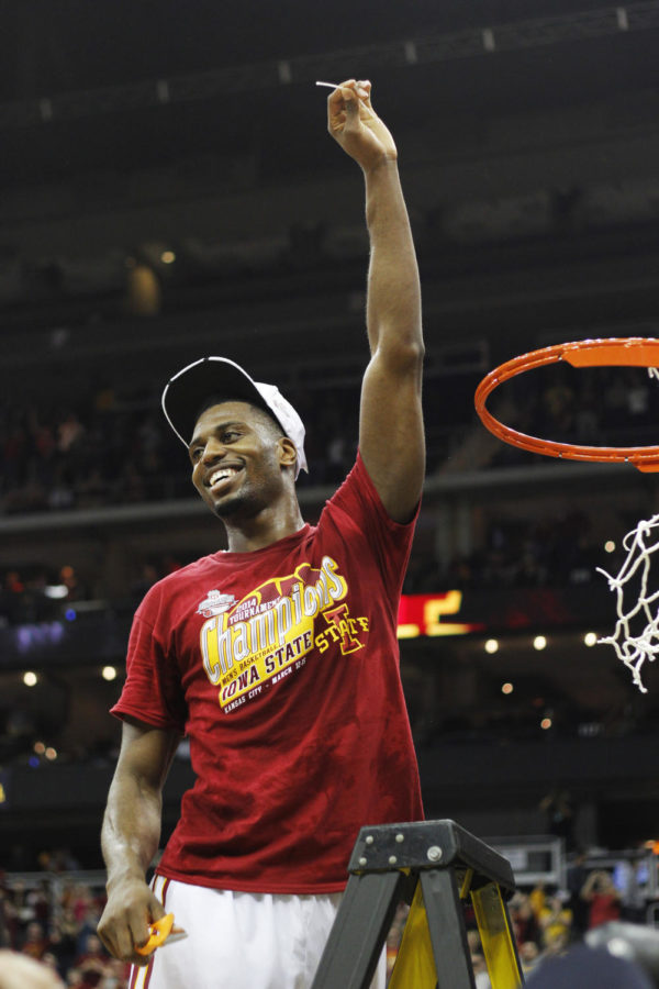 Senior forward Melvin Ejim holds up a piece of the net after Iowa States win against Baylor in the Phillips 66 Big 12 Championship final game March 15 in Kansas City, Mo. The Cyclones defeated the Bears 74-65 in their first appearance in the final round since 2000.