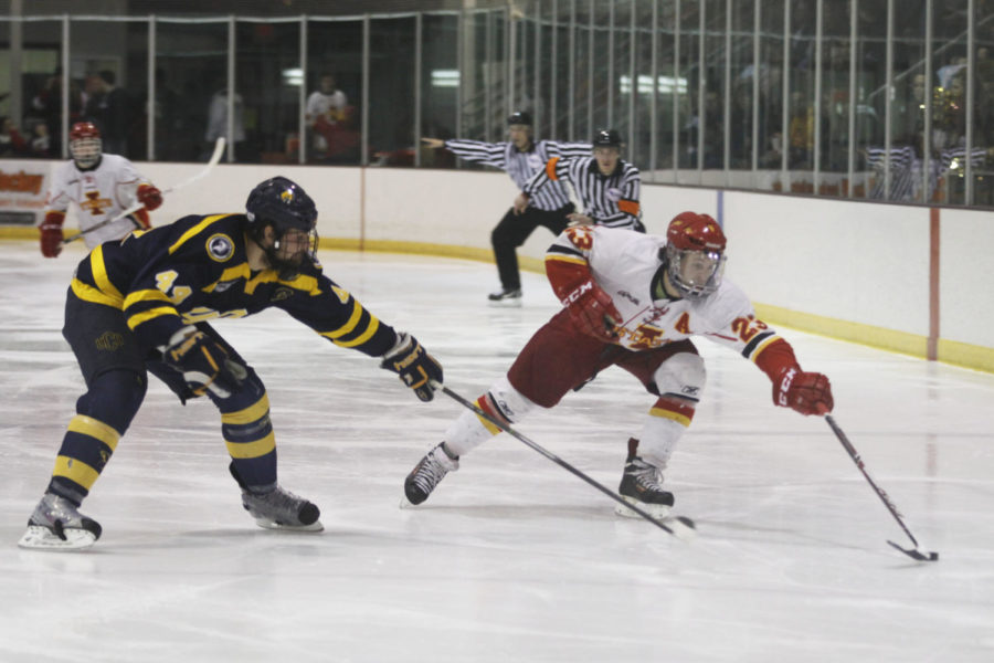 Junior forward Chris Cucullu fights for the puck during the game against University of Central Oklahoma on Feb. 15 at Ames/ISU Ice Arena. The Cyclones fell to the Bronchos 6-3 in their final game of the regular season.