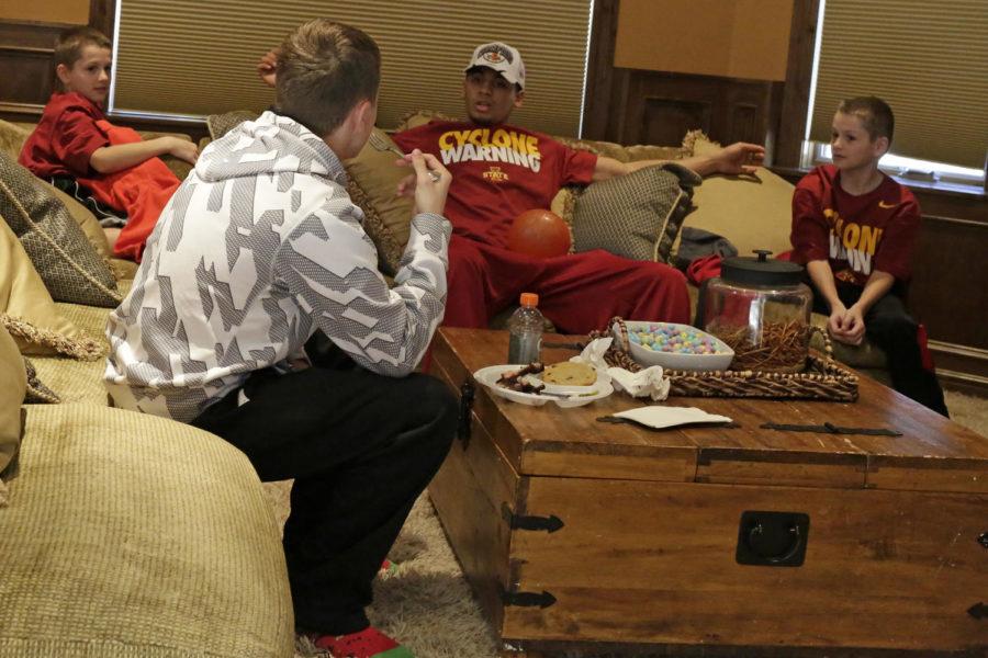 Sophomore guard Naz Long sits with head coach Fred Hoibergs sons before the start of the selection show March 16 at Hoibergs house.