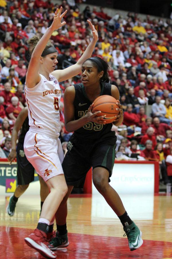 Senior forward Hallie Christofferson attempts to block an opposing Baylor player during the Cyclones game against Baylor at Hilton Coliseum March 4. After a slow start, the Cyclones picked up their game to tighten the point gap, but ultimately the Cyclones fell to the Lady Bears 70-54. This was the Cyclones senior night game.