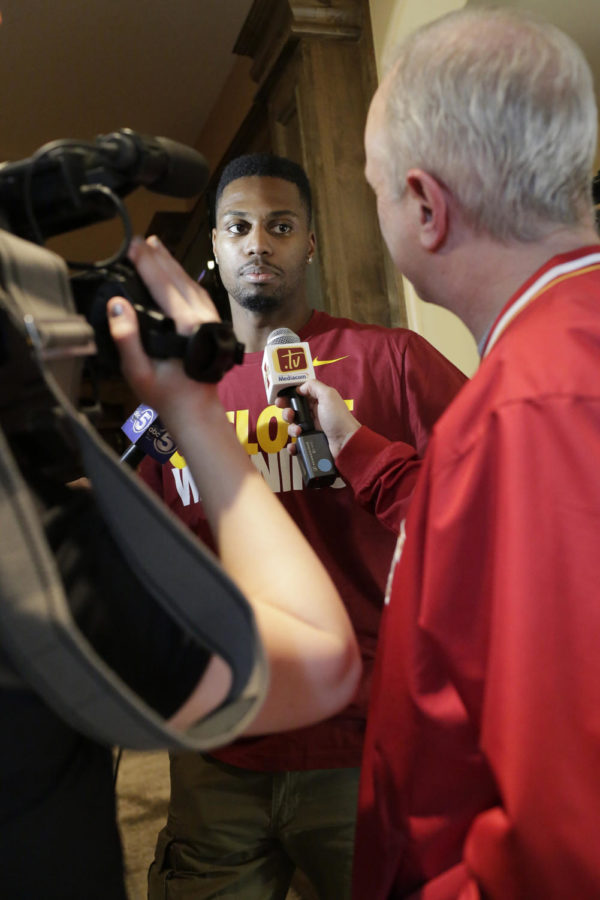 Senior forward Melvin Ejim gets interviewed after it was announced that Iowa State is the third seed in the east division of the NCAA tournament. Ejim, along with his teammates, watched the selection show at ISU coach Fred Hoibergs house.