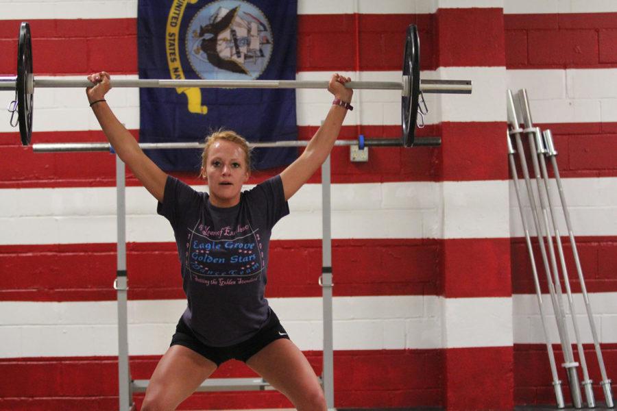 Mollie McGrath, a 2011 UNI graduate and wellness coach at Powerful Nutrition in Ames, works during an early morning CrossFit session. The Factory has opened up its facilities to members of Iowa State ROTC for free use.