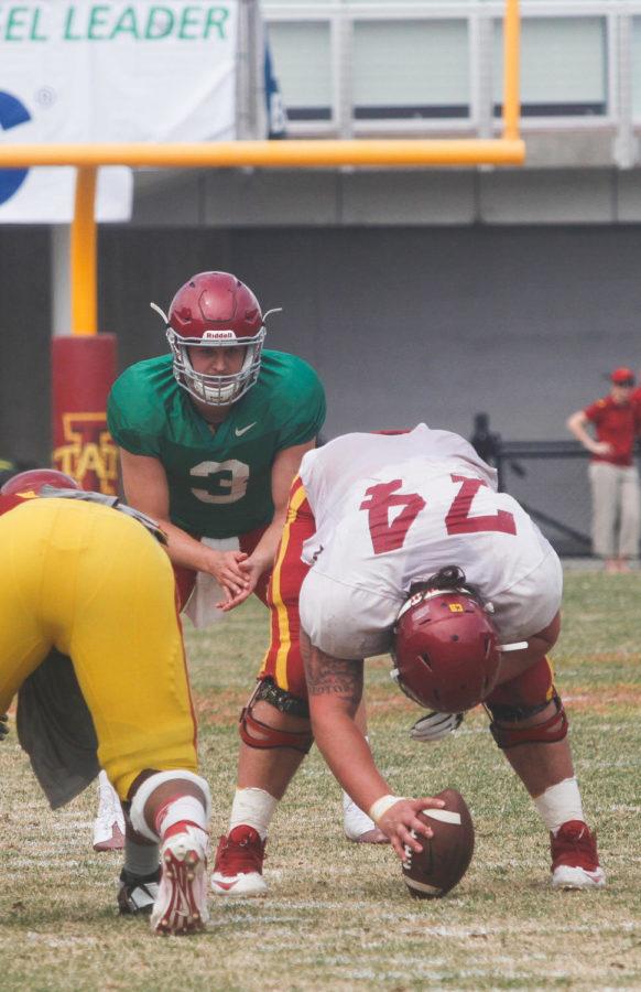 Redshirt senior center Tom Farniok hikes the ball to redshirt sophomore quarterback Grant Rohach during the spring game at Jack Trice Stadium on April 12. 