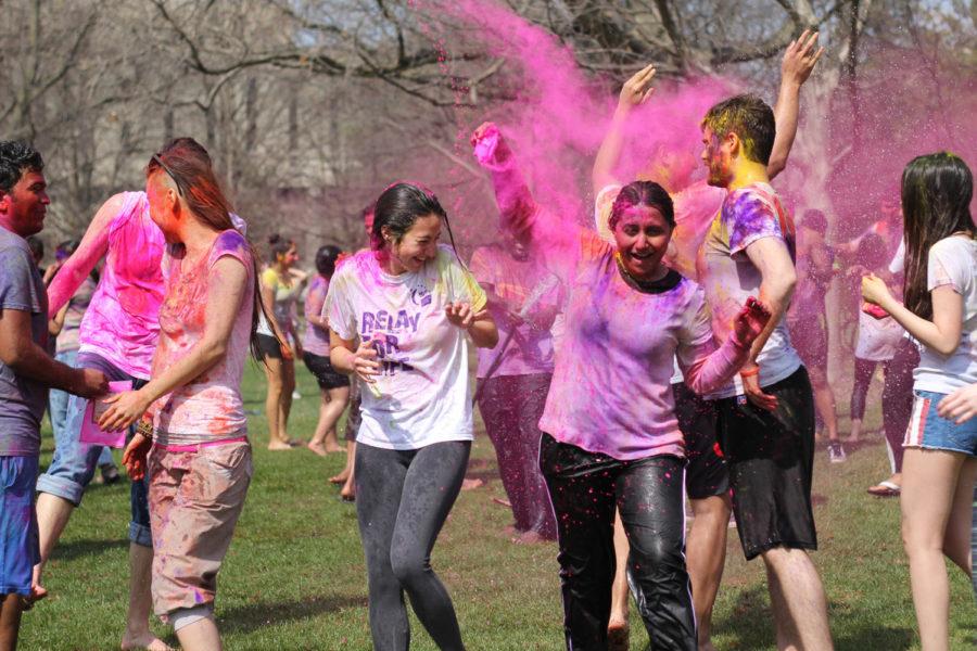 Students douse each other in bright powder during the Indian Student Associations Holi festival, which occurred on the south lawn of Central Campus on Saturday, April 19. Participants celebrated by throwing brightly colored organic powders at one another.