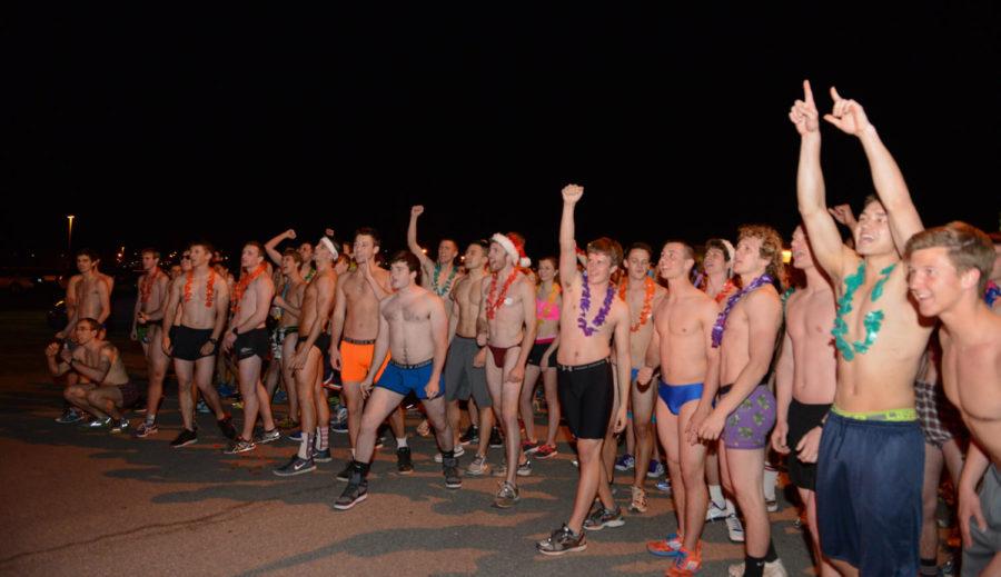 The Nearly Naked Mile runners cheer before the beginning of the race on April 25 at the Jack Trice Stadium parking lot.