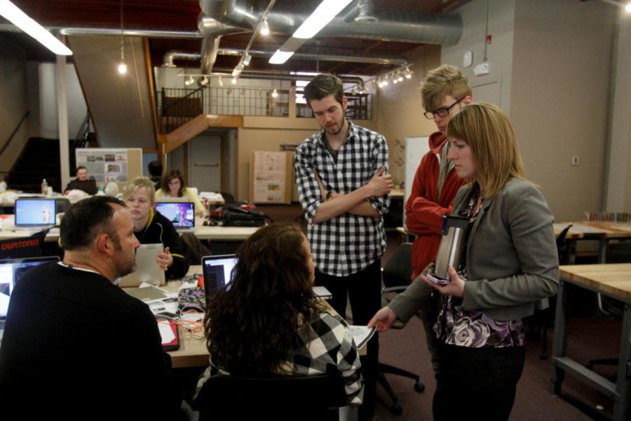Design students work with their professor Lisa Bates, far right, and Tom Neppl, far left, for the Iowa Retail Initiative at the Design studio workplace on Main Street on April 16. 