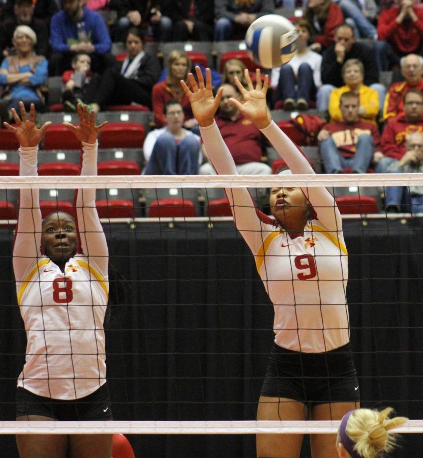 Monique Harris, left, and Samara West, right, block the ball in the second game of the volleyball tournament on Saturday, April 5 at Hilton Coliseum.