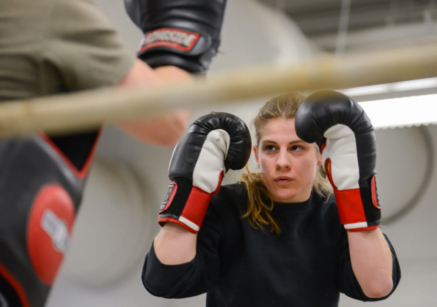 Olivia Meyer, junior in biology, practices with boxing coach Jon Swanson on April 1 in State Gym. She is going to compete in her first NCBA National Championships on April 3-5 at West Point, N.Y.