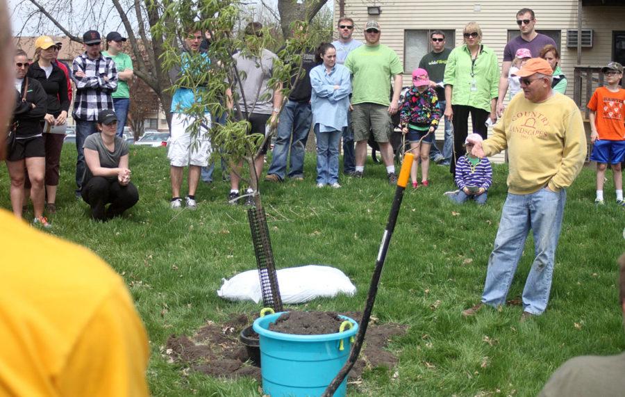 Jim Mason co-found Country Landscape in 1981. Mason demonstrated how to plant a tree properly to a crowd of volunteers on April 26 at Gateway Park.