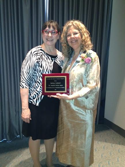 Dr. Barbara Caldwell, right, receives the USSEA Ziegfeld Service Award from Dr. Patricia Belleville, the USSEA Ziegfeld Awards Chair. 