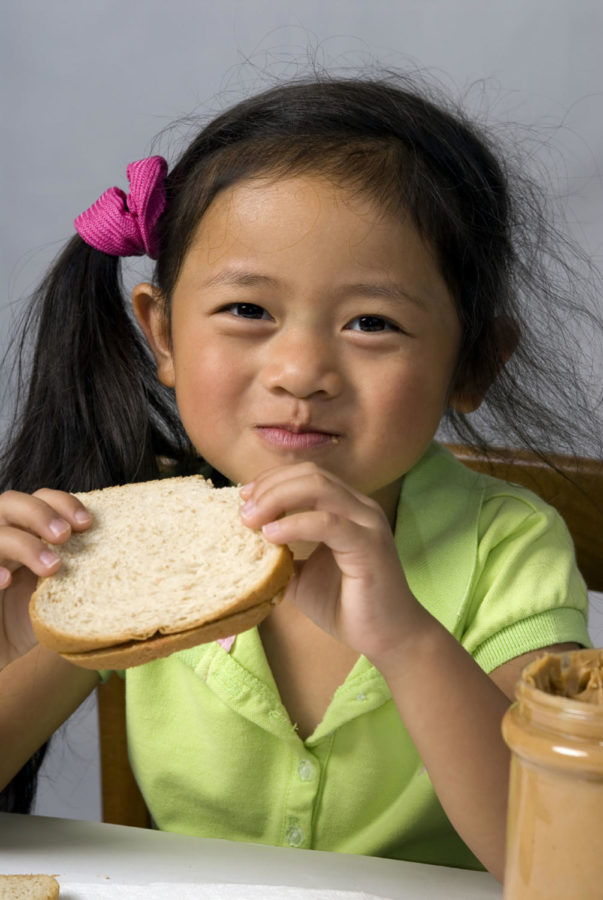Xiu Chen eats a sandwich at the Child Development Laboratory School located in the Palmer Building.