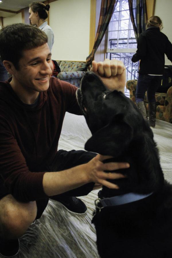 Eric Reents, freshman in kinesiology, plays with Sally at the Inter-Residence Hall Associations Pet Therapy event in Linden Hall on April 23. Rescue dogs were available for students to play with to relieve the added stress of the end of the spring semester as many students prepare for the summer.