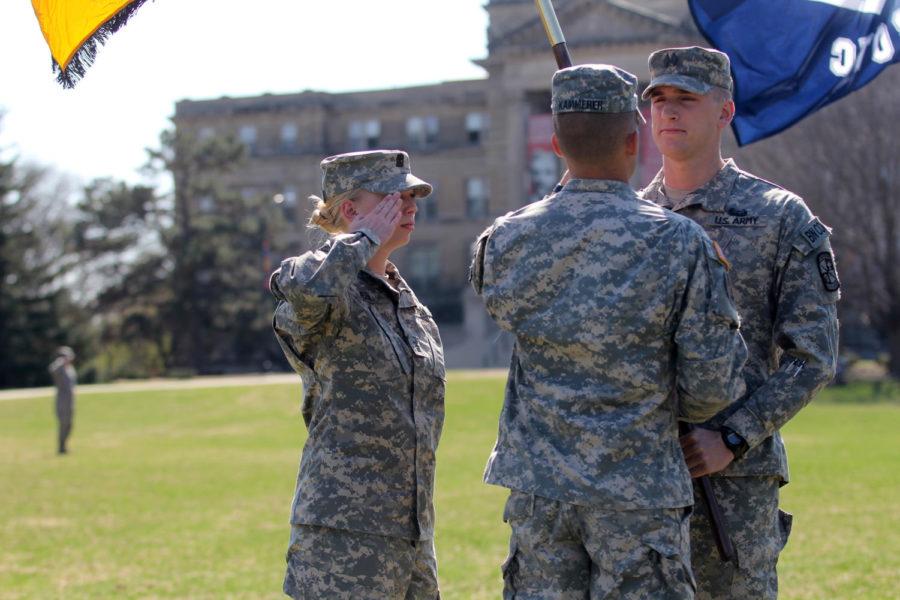 Cadet Amanda Veen, outgoing cadet battalion commander Zach Graham and incoming cadet battalion commander Andrew Kammerer swap the Army ROTC guidon during the Change of Command ceremony on April 22.