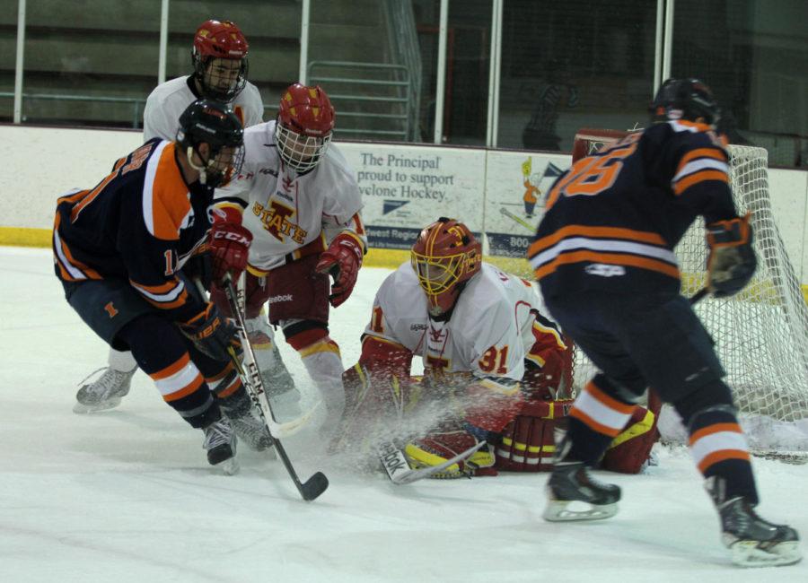 Goalie Matt Cooper saves a goal during the game against Illinois on Feb. 7. After going 0-2 in the first period, the Cyclones came back to score three goals in the second and two in the third to give them the 5-2 win over the Fighting Illini.